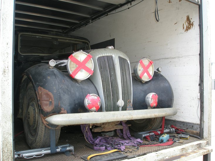 Daimler, loaded on truck, with headlights taped to prevent damage to the galss